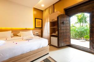 a bedroom with two beds and a large window at The Lemonary Marrakech in Marrakech