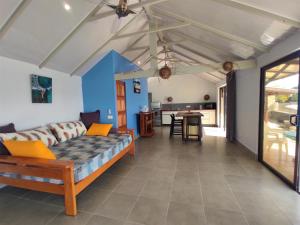 a living room with a couch and a table at TAHITI - Taharaa Beach Bungalow in Arue
