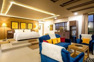 a bedroom with a bed and two chairs at The Lemonary Marrakech in Marrakech