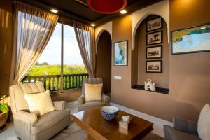 a living room with chairs and a table and a balcony at The Lemonary Marrakech in Marrakech