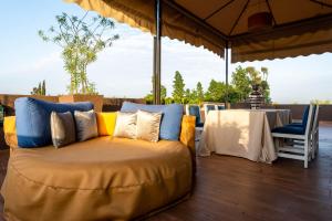 a couch sitting under an umbrella on a patio at The Lemonary Marrakech in Marrakech
