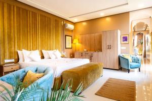 a hotel room with a bed and two chairs at The Lemonary Marrakech in Marrakech
