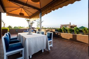 a white table and chairs on a balcony at The Lemonary Marrakech in Marrakech