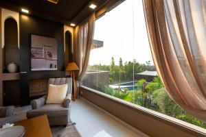 a living room with a large window with a view at The Lemonary Marrakech in Marrakech