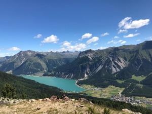 a view of a lake in the mountains at Cosy Apartment Marlain in San Valentino alla Muta +5 photos