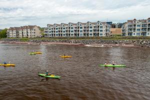a group of people in kayaks in a body of water at Beacon Pointe on Lake Superior in Duluth
