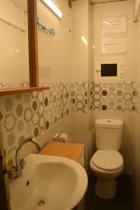 a small bathroom with a toilet and a sink at City Hostel Dormitory in Trâblous