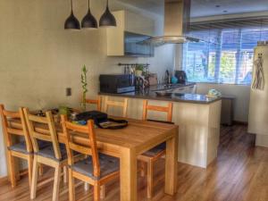 a kitchen with a wooden table and chairs in a kitchen at Cozy Dutchie House Near Utrecht in Nieuwegein