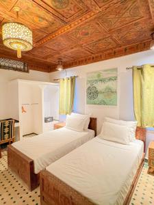 Krevet ili kreveti u jedinici u objektu Desert Villa Boutique Hotel Merzouga