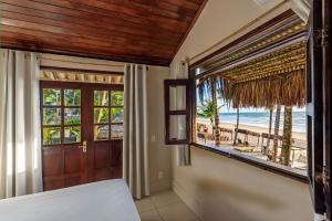 a bedroom with a view of the beach at Rumah Pousada in Barra Grande