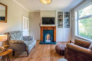 a living room with a fireplace and a couch at Rose Cottage Halesworth Air Manage Suffolk in Halesworth