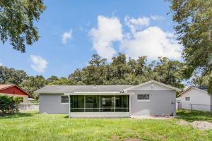 a white house with a garage at Quiet Location Duplex House - Minutes Away from Everything - Winter Park, Florida in Orlando