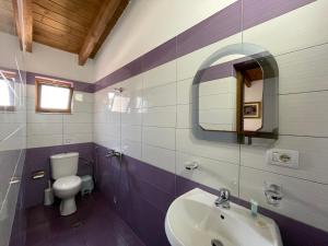 a bathroom with a sink and a toilet and a mirror at Summer Dreams in Ksamil
