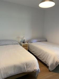A bed or beds in a room at Villa May en Riegu Vidiago Llanes