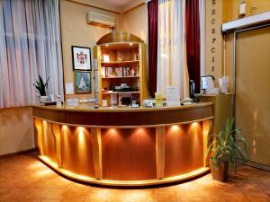 a hotel lobby with a reception counter with lights at Hotel Slodes in Belgrade