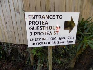 a sign that reads entrance to a pizza practition at Protea Guest House in Knysna