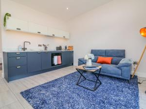 sala de estar con sofá azul y mesa en The Cadeleigh, en Tiverton