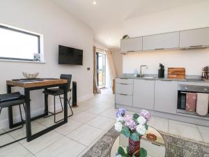 a kitchen and dining room with a table and a table sidx sidx sidx at The Bickleigh in Tiverton