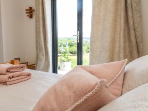 a bedroom with a bed and a large window at The Bickleigh in Tiverton