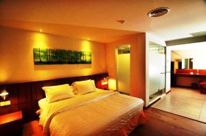 a bedroom with a large bed in a room at French Hotel in Ipoh