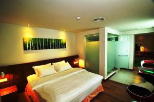 a bedroom with a large bed in a room at French Hotel in Ipoh