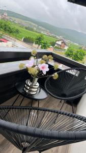 a vase of flowers on a table on a balcony at Pensiunea Heaven in Alba Iulia
