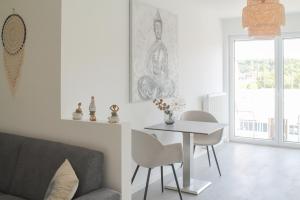 a living room with a couch and a table at Buddha Apartment in Koblenz
