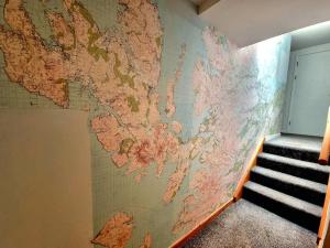 a map of the world on a wall next to a staircase at One Bed Holiday Home in the Heart of Inverness in Inverness