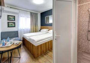 Postel nebo postele na pokoji v ubytování Guesthouse Check In