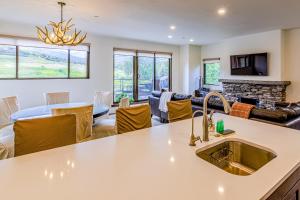 a kitchen and living room with a sink and a couch at Snowmas Village 1624 in Snowmass Village