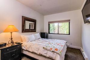 a bedroom with a large bed and a window at Snowmas Village 1624 in Snowmass Village