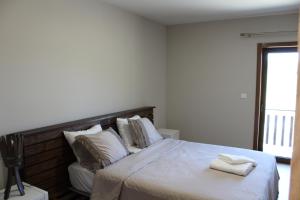 Giường trong phòng chung tại Quinta Do Marmeiral