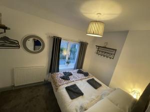 a bedroom with a bed and a window at Two bed holiday home in Conwy in Conwy