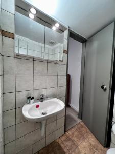 a bathroom with a sink and a mirror at Central Single Room Ground floor in Heraklio
