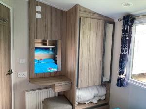 a cabinet with a television in a room at Blackpool caravans Marton mere in Blackpool