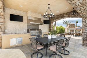 a kitchen and dining room with a table and chairs at Villa Bella - Private Estate in the Heart of Palm Desert, Outdoor Amenities, Gym, Game Room in Palm Desert