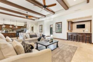 a living room with a couch and a table at Villa Bella - Private Estate in the Heart of Palm Desert, Outdoor Amenities, Gym, Game Room in Palm Desert