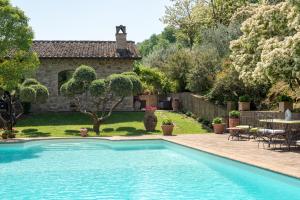 una piscina in un cortile con una casa di Santa Croce Resort a Torgiano