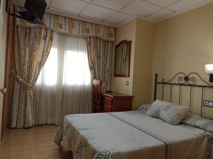 Postel nebo postele na pokoji v ubytování Hotel Beatriz