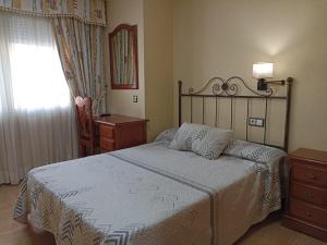 Postel nebo postele na pokoji v ubytování Hotel Beatriz