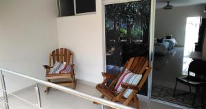 two rocking chairs sitting in a living room at Hotel PZ Country Club & Conference Center in San Isidro