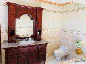 a bathroom with a sink and a toilet and a mirror at Casa Fermin in Corbanal