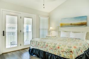 a bedroom with a bed and two windows at 5 C, Three Bedroom Townhome in Destin