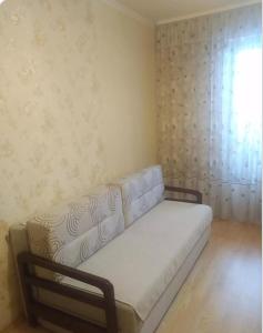 a small bed in a room with a window at квартира в районі автовокзалу поряд обллікарня in Rivne