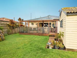 a backyard with a house with a fence at Room @ 88 in Devonport