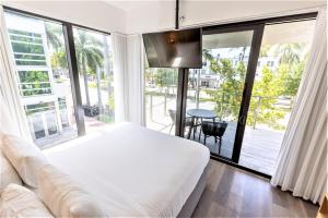 a bedroom with a large window and a large bed at URBANICA The Euclid in Miami Beach