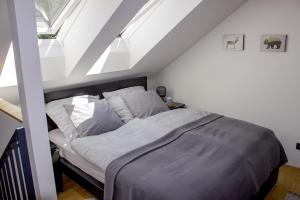 Postel nebo postele na pokoji v ubytování Enjoy Harrachov - Atraktivní klimatizovaný mezonetový apartmán 20 v centru Harrachova s výhledem do zahrady, na romantický kostelík a nabíjecí stanicí pro elektromobil