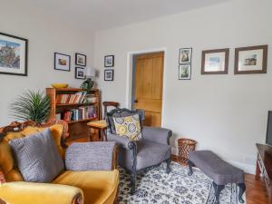 a living room with a couch and two chairs at 5 East Street in Skipton