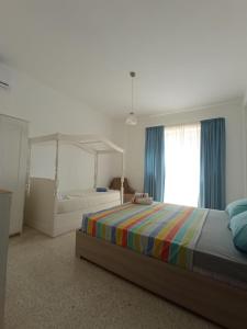 a bedroom with a bed and a large window at Double bedroom with private bathroom, NO KITCHEN in Il-Gżira