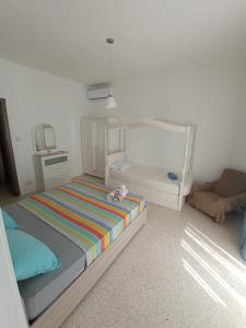 a bedroom with a bed with a stuffed animal on it at Double bedroom with private bathroom, NO KITCHEN in Il-Gżira